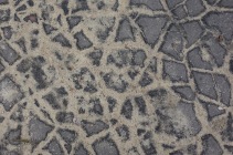 De-icing sand in a cracked pavement